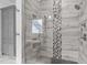 Modern bathroom featuring a large glass shower with gray tile and mosaic accents at 6648 Mafolie Ct, Raleigh, NC 27613