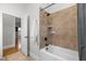 Clean bathroom with white bathtub and shower with tiled wall and bronze fixtures at 6648 Mafolie Ct, Raleigh, NC 27613