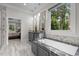 Elegant bathroom features soaking tub, double sinks, and bright natural light at 6648 Mafolie Ct, Raleigh, NC 27613