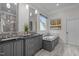Elegant Primary bath with double vanity, soaking tub, and marble countertops at 6648 Mafolie Ct, Raleigh, NC 27613