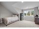 Bright bedroom featuring a cozy bed, bookshelf, and window overlooking the outdoor greenery at 6648 Mafolie Ct, Raleigh, NC 27613