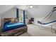 Brightly lit bedroom with hardwood bed frame, fun decorations, and large windows bringing in natural light at 6648 Mafolie Ct, Raleigh, NC 27613