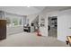 Bedroom with a writing desk, bookshelf, an open closet, and large windows offering outdoor views at 6648 Mafolie Ct, Raleigh, NC 27613