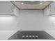 Close-up of the modern cooktop with sleek design and stylish backsplash at 6648 Mafolie Ct, Raleigh, NC 27613