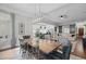 Beautiful dining room featuring wood table, patterned chairs, modern lighting, and open floor plan at 6648 Mafolie Ct, Raleigh, NC 27613