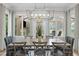 Elegant dining room with large windows and an elaborate chandelier at 6648 Mafolie Ct, Raleigh, NC 27613