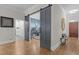 Inviting entryway featuring hardwood floors, sliding barn doors, and access to the kitchen and office at 6648 Mafolie Ct, Raleigh, NC 27613