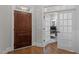 Inviting entryway with a beautiful wood door and an open view into the bright home office at 6648 Mafolie Ct, Raleigh, NC 27613