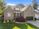Beautiful brick home featuring a lush green lawn and an attached garage at 6648 Mafolie Ct, Raleigh, NC 27613