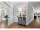 Hallway with hardwood floors, decorative cabinet, and natural light, creating an open feel at 6648 Mafolie Ct, Raleigh, NC 27613