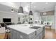 Spacious kitchen with a large center island, stylish pendant lighting, and stainless steel appliances at 6648 Mafolie Ct, Raleigh, NC 27613