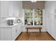 Bright kitchen featuring white cabinetry and hardwood floors at 6648 Mafolie Ct, Raleigh, NC 27613