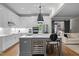 Modern kitchen with a wine fridge, stainless appliances, and large center island with bar seating at 6648 Mafolie Ct, Raleigh, NC 27613