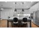 Bright kitchen with oversized island, pendant lights, and stainless appliances at 6648 Mafolie Ct, Raleigh, NC 27613