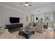 Comfortable living room with stylish armchairs, modern decor, and view into the dining area at 6648 Mafolie Ct, Raleigh, NC 27613