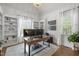 Bright home office with vaulted ceilings, built-in bookshelves, and large windows at 6648 Mafolie Ct, Raleigh, NC 27613