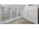 Built-in shelving unit with glass shelves and a modern refrigerator in a finished basement at 6648 Mafolie Ct, Raleigh, NC 27613