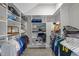 Bright walk-in closet with ample shelving and hanging space for clothes and accessories at 6648 Mafolie Ct, Raleigh, NC 27613