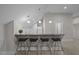 Modern wet bar with counter seating, a sink, and a clean, minimalist design at 6648 Mafolie Ct, Raleigh, NC 27613