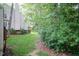 Backyard of home with tree coverage and home exterior at 6685 English Ivy Ln, Raleigh, NC 27615