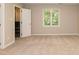 Bright bedroom featuring neutral paint, carpet, large window, and a closet at 6685 English Ivy Ln, Raleigh, NC 27615