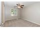 Bedroom with neutral paint, carpet, a ceiling fan, and a window at 6685 English Ivy Ln, Raleigh, NC 27615
