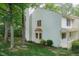 Charming two-story home with white siding, chimney, mature trees, and a well-maintained lawn at 6685 English Ivy Ln, Raleigh, NC 27615