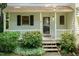 Inviting front porch with wooden steps and lovely shrubbery at 6685 English Ivy Ln, Raleigh, NC 27615