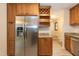 Spacious kitchen featuring stainless refrigerator and plenty of cabinets at 6685 English Ivy Ln, Raleigh, NC 27615
