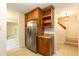 Kitchen with stainless refrigerator, wine rack, and tile flooring at 6685 English Ivy Ln, Raleigh, NC 27615