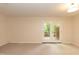 Bright and airy living room with access to a wooden deck through glass doors at 6685 English Ivy Ln, Raleigh, NC 27615