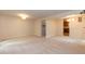 Large living room featuring carpet flooring with seamless transition to the kitchen at 6685 English Ivy Ln, Raleigh, NC 27615