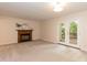 Spacious living room with a fireplace and access to the outdoor deck through glass doors at 6685 English Ivy Ln, Raleigh, NC 27615