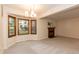 Bright living room with a fireplace, carpet flooring, and large windows offering scenic views at 6685 English Ivy Ln, Raleigh, NC 27615
