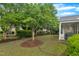 Well-manicured backyard featuring trees, bushes, and lawn near the home at 804 Harsworth Dr, Cary, NC 27519
