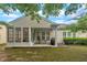 Backyard featuring a screened porch, patio area with grill, and lawn at 804 Harsworth Dr, Cary, NC 27519