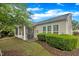 Backyard featuring a screened porch, patio area with grill, and lawn with greenery at 804 Harsworth Dr, Cary, NC 27519