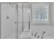 Bathroom showing a glass enclosed shower, jetted tub, and bright window with privacy shutters at 804 Harsworth Dr, Cary, NC 27519