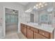 Bright bathroom featuring a double vanity with natural wood cabinets and a large mirror at 804 Harsworth Dr, Cary, NC 27519