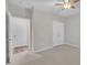 Neutral bedroom featuring a ceiling fan, carpeted floor, and white closet doors at 804 Harsworth Dr, Cary, NC 27519