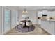 Charming dining area next to kitchen with modern lighting and light-colored wood flooring at 804 Harsworth Dr, Cary, NC 27519
