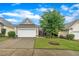 Charming single-story home featuring a well-manicured lawn, two-car garage, and a welcoming stone-lined entryway at 804 Harsworth Dr, Cary, NC 27519
