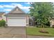 Charming single-story home with a manicured lawn, two-car garage, and stone-lined entryway at 804 Harsworth Dr, Cary, NC 27519