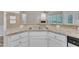 Kitchen bar top with granite counters and stainless sink, with view to the living area with fireplace at 804 Harsworth Dr, Cary, NC 27519