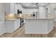 Well-lit kitchen featuring stainless steel appliances, granite countertops, white cabinets, and a central island at 804 Harsworth Dr, Cary, NC 27519