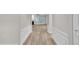 Bright living room boasts light-colored wood floors, white trim, and a view into another living space at 804 Harsworth Dr, Cary, NC 27519