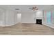 Bright living room with modern floors, fireplace, and seamless transition to the dining area at 804 Harsworth Dr, Cary, NC 27519