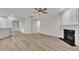 Open-concept living space featuring modern flooring, fireplace, and seamless flow to the kitchen at 804 Harsworth Dr, Cary, NC 27519