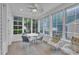 Sunroom featuring multiple windows, ceiling fan, and seating area with table and chairs at 804 Harsworth Dr, Cary, NC 27519