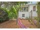 Relaxing backyard features a hammock and seating area at 826 Rushing, Pittsboro, NC 27312